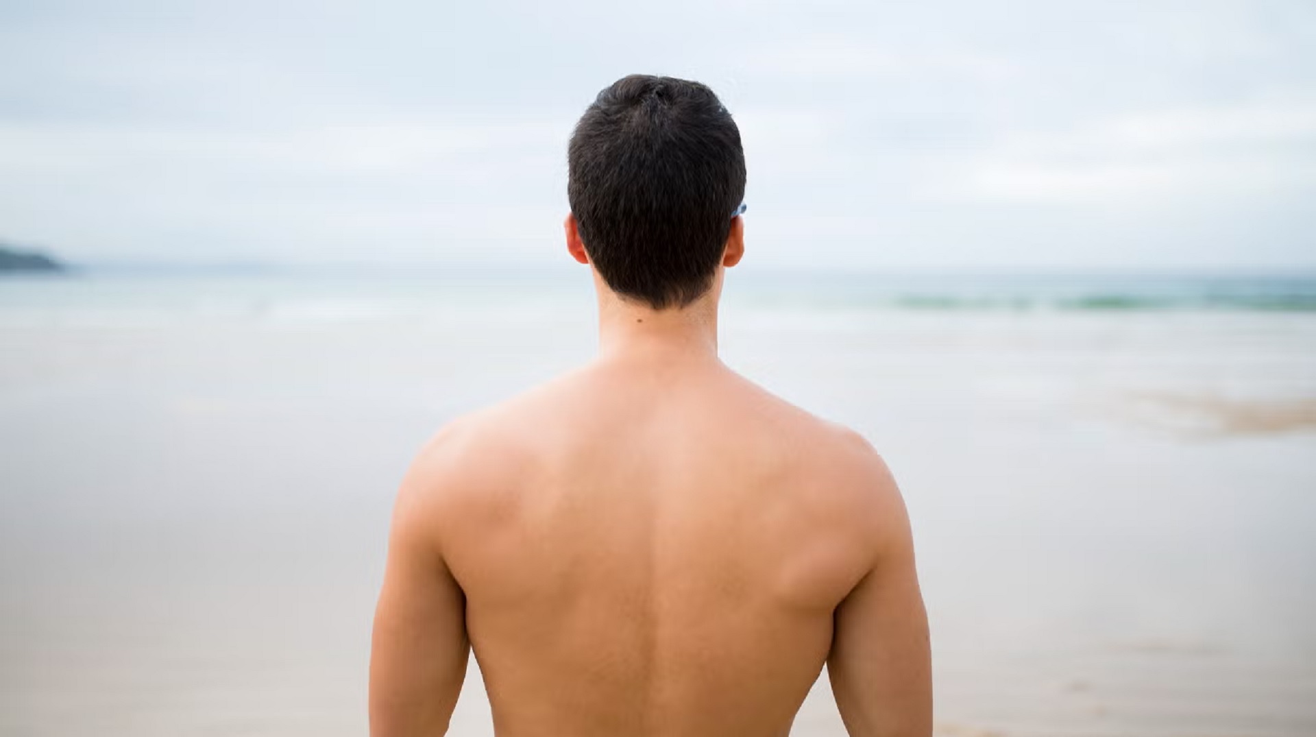 افتادگی شانه های مرد لخت در ساحل